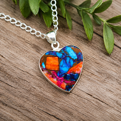 Close-up of heart shaped copper turquoise pendant showing blue and orange composite stone detail