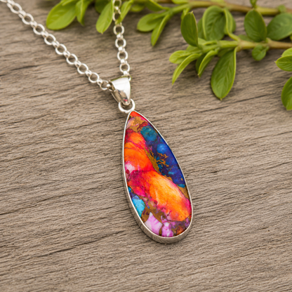 Close-up of teardrop shaped copper turquoise pendant showing orange, pink and blue composite stone detail