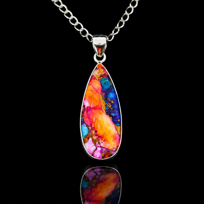 Sterling silver teardrop pendant necklace close-up on neutral background