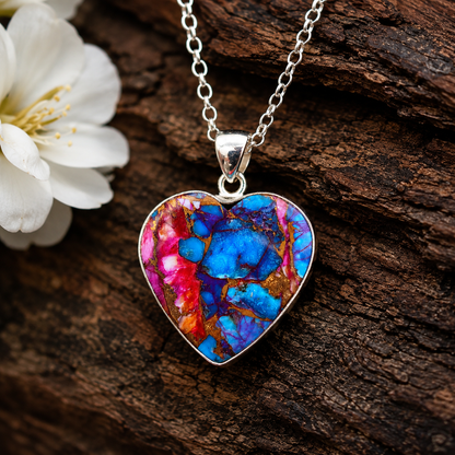 Close-up of heart shaped copper turquoise pendant showing blue and pink composite stone detail