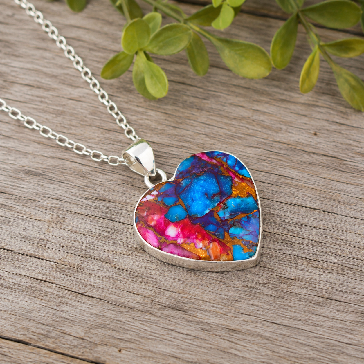 Sterling silver heart pendant necklace with copper turquoise stone, angled view